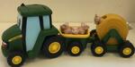 John Deere tractor with trailers and animals