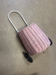 Pink wheeled shopping basket