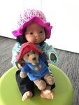Asian doll with Paddington bear toy 