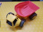 YELLOW DUMP TRUCK WITH RED TRAY