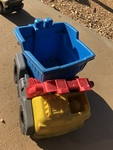 Outside yellow and red dump truck with blue bucket 
