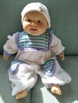Baby doll with white and purple jumpsuit and beanie