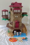 Old oak tree house and koala family