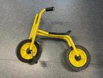 Yellow balance bike with pedals