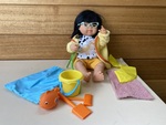 Girl doll with glasses and beach gear