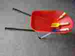 Garden tools and red wheelbarrow