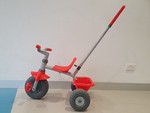 Red trike with push handle