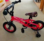 RO20: Red Milazo Hercules bike with training wheels