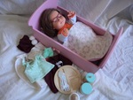 Vision impaired doll in a cradle