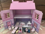 Wooden dollhouse with family