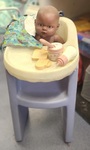 Doll with high chair and accessories