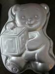 Teddy bear with block cake tin